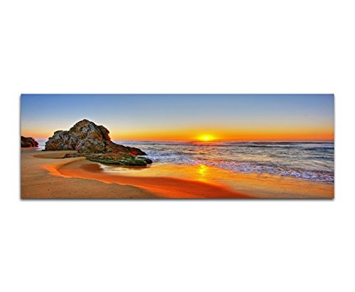 Paul Sinus Art Panoramabild auf Leinwand und Keilrahmen 150x50cm Strand Meer Sonnenaufgang Fels