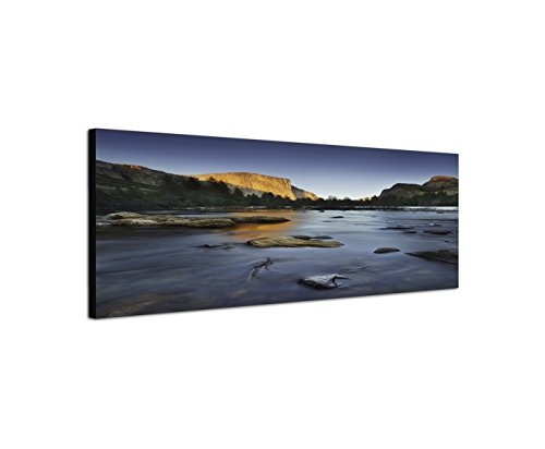 Wandbild auf Leinwand als Panorama in 150x50cm Felsen Bäume Fluss Steine Abendlicht