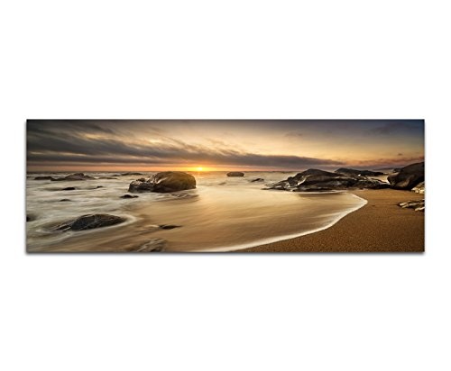 Paul Sinus Art Panoramabild auf Leinwand und Keilrahmen 150x50cm Meer Strand Steine Sonnenaufgang Wolken
